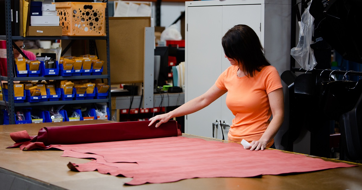 Manufacturing employee works at table