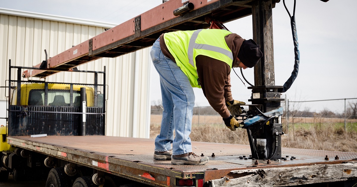 Employee attaches trailer to truck