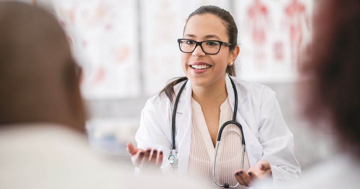 Physician discusses medical treatment with patients