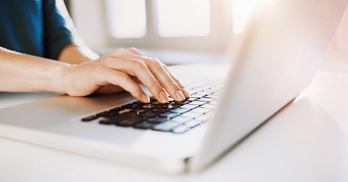 Female hand on a laptop keyboard